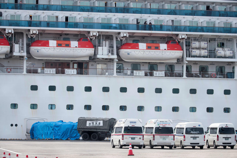 Image: A military vehicle is attached to a gate of the Diamond Princess cruise ship at the Daikaku Pier Cruise Terminal in Yokohama port