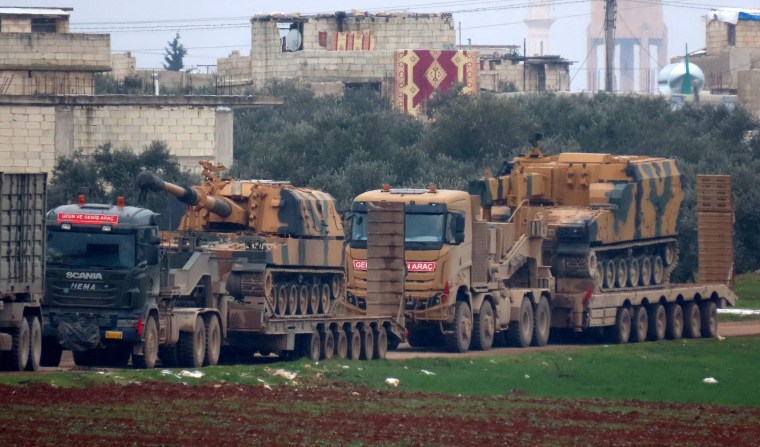 Image: Turkish military vehicles in the town of Binnish in Syria's northwestern Idlib province