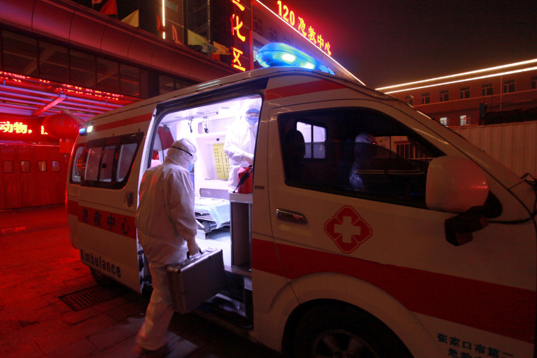 Image: A medical worker in protective suit gets onto an ambulance at a hospital, following an outbreak of the novel coronavirus in the country, in Xuanhua district of Zhangjiakou