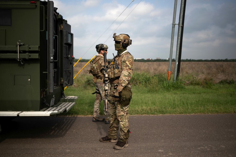 Agents with the U.S. Border Patrol Tactical Unit hold weapons from a armored vehicle ahead of exercises in Mission, Texas