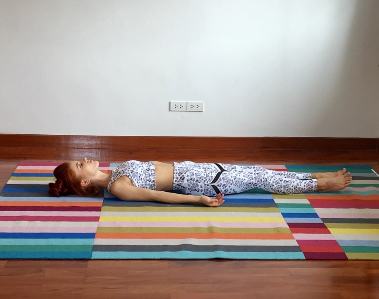 Woman Lying On Bed Against Wall At Home