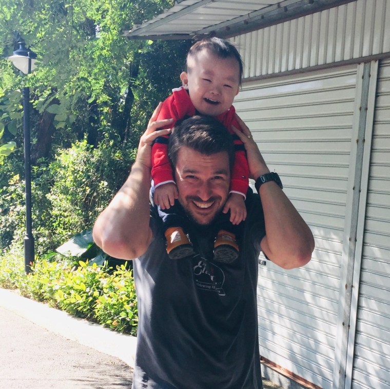 Cady Driver's husband, Chris, with their son, Lian, who has Down syndrome and was adopted from China in 2016.