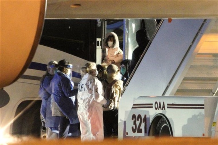 American evacuees from the coronavirus outbreak in China board a bus after arriving by plane to Eppley Airfield in Omaha, Neb., on Feb. 7, 2020.