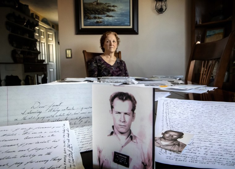 Image: Janet Uhlar sits with letters and pictures she received from James \"Whitey\" Bulger at her home in Eastham, Mass., on Jan. 31, 2020. Uhlar was one of 12 jurors who found Bulger guilty in a racketeering case, but now regrets voting to convict him.