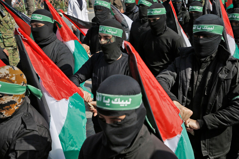 Image: Masked Palestinian militants protest the US-brokered peace plan in Gaza City
