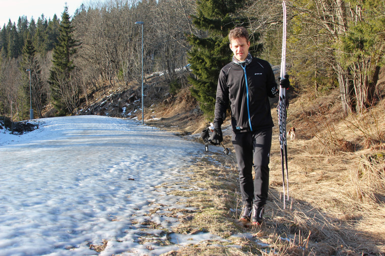 Fredrik Kottmann, 47, walks alongside the little snow that has fallen on Norway in recent months.