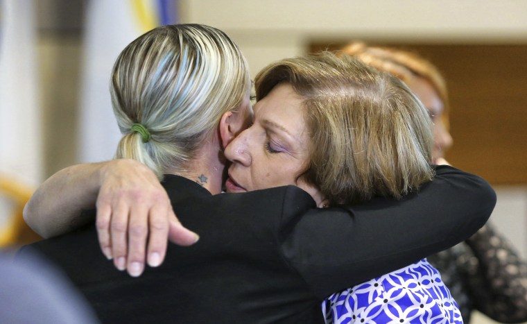 Tina Franke, right, the mother of murder victim Christine Franke, gets a hug from Christine's niece, Ashley, after a press conference on Nov. 5, 2018, at Orlando Police Department headquarters announcing the solving of the cold case from 2001.