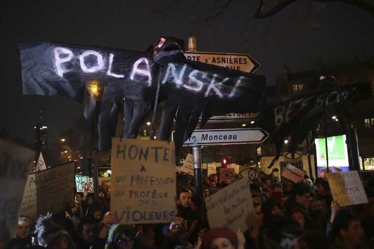 Protesters held up signs outside the venue of the Cesar awards ceremony, the French equivalent of the Oscars on Friday.