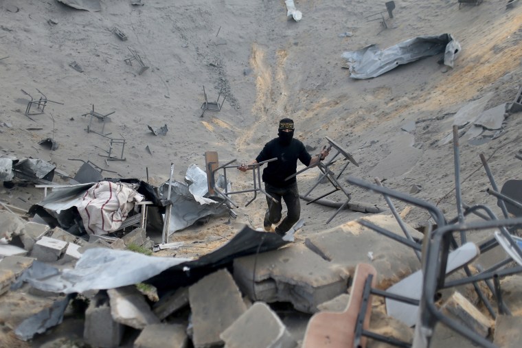 Image: A Palestinian surveys an Islamic Jihad site in Gaza that was targeted in an Israeli air strike.