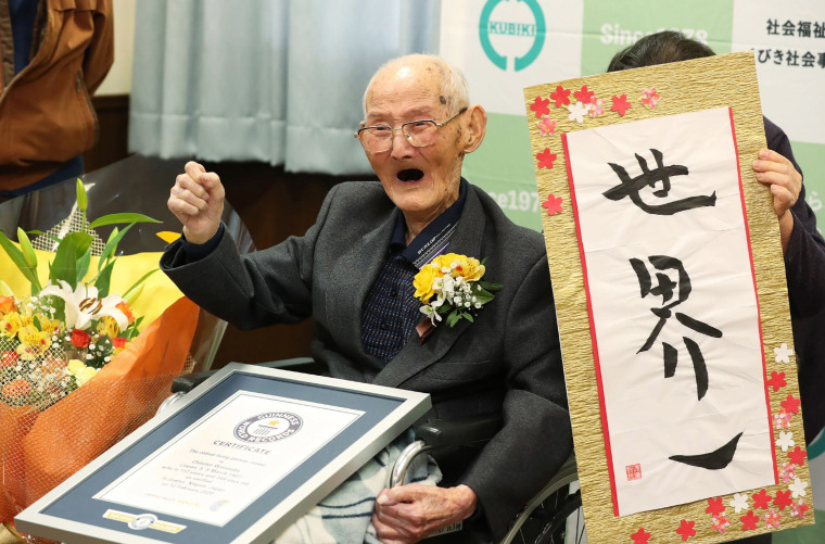 Image: 112-year-old Japanese man Chitetsu Watanabe poses next to calligraphy reading in Japanese 'World Number One' after he was awarded as the world's oldest living male in Joetsue