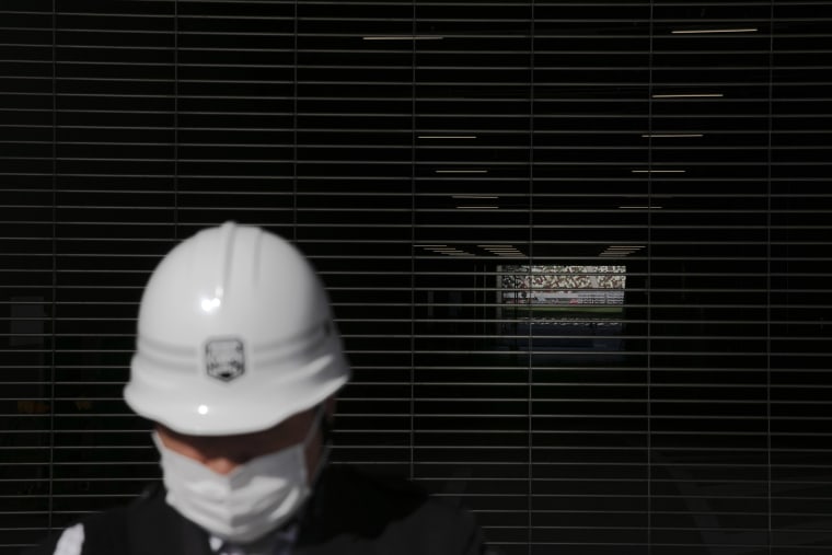 Image: Security guard at New National Stadium in Tokyo