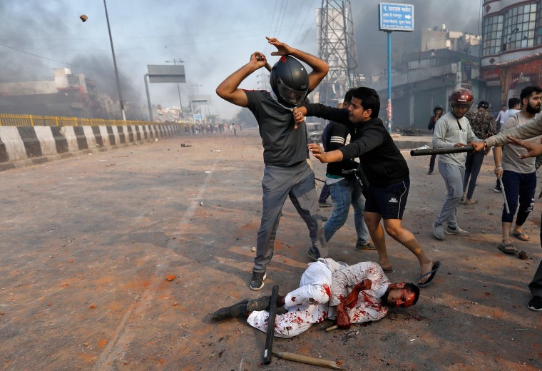 Image: A Muslim is beaten by people supporting a new citizenship law beat in New Delhi 