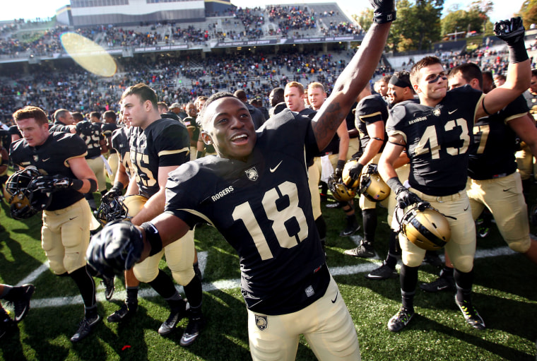Image: Army Black Knights defensive back Jared Rogers celebrates with teammates after West Point defeated the Bucknell Bison during a game in 2015.