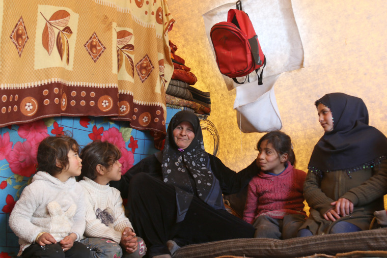 Image: Zaheda Alhussain with her grandchildren at a camp in Idlib.