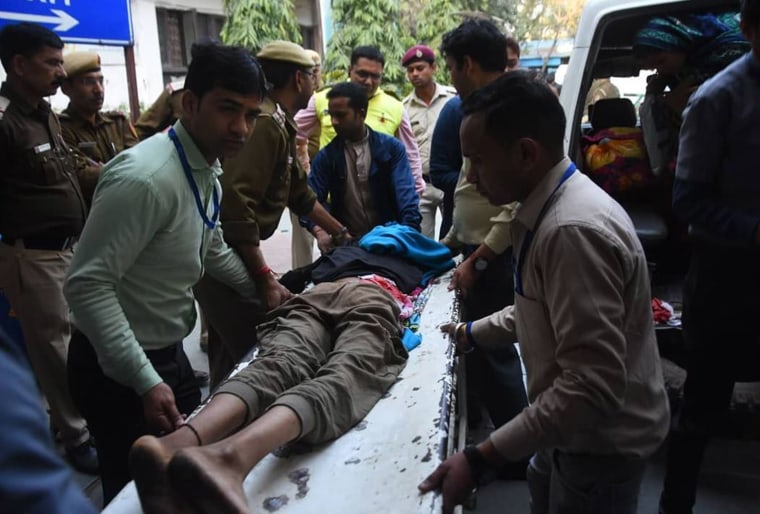 Image: A teenager is taken to hospital after being shot in the waist in Kardam Puri, New Delhi on Tuesday, Feb. 25.