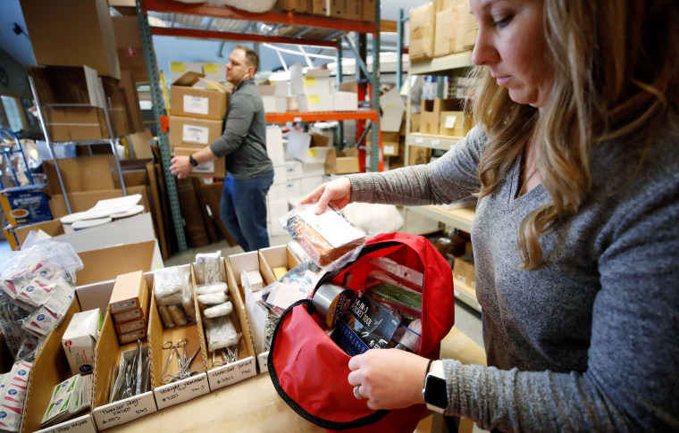 Kristen Curley, owner of Nitro-Pak, puts items into a backpack as part of personal protection and survival equipment kits ordered by customers preparing against coronavirus at Nitro-Pak in Midway, Utah.
