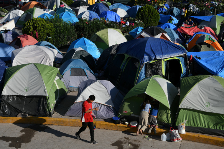 Image: Migrants, most of them asylum seekers sent back to Mexico from the U.S. under the \"Remain in Mexico\" program officially named Migrant Protection Protocols (MPP), occupy a makeshift encampment in Matamoros