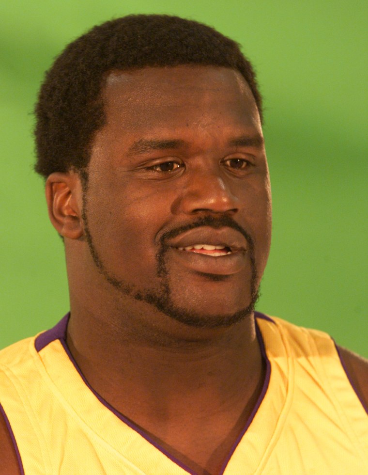 Laker center Shaquille O'Neal poses for the cameras during the team's media day at their training fa