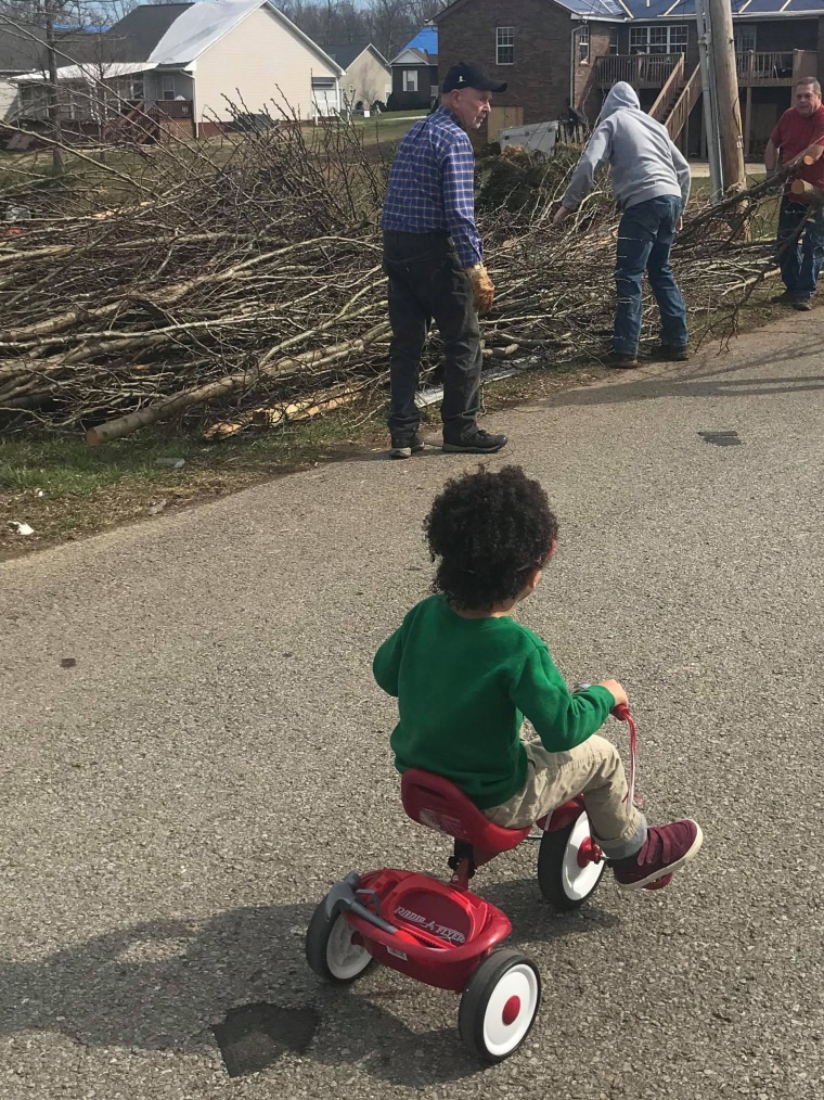 Dax looks at the damage after the tornado Tuesday.