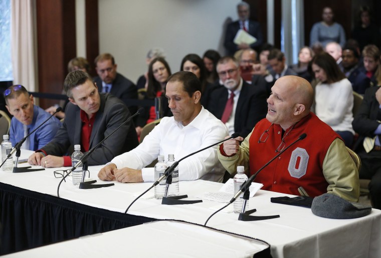 Michael DiSabato, right, speaks with other victims of former Ohio State team doctor Dr. Richard Strauss, at the university's board of trustees meeting on Nov. 16, 2018 in Columbus.