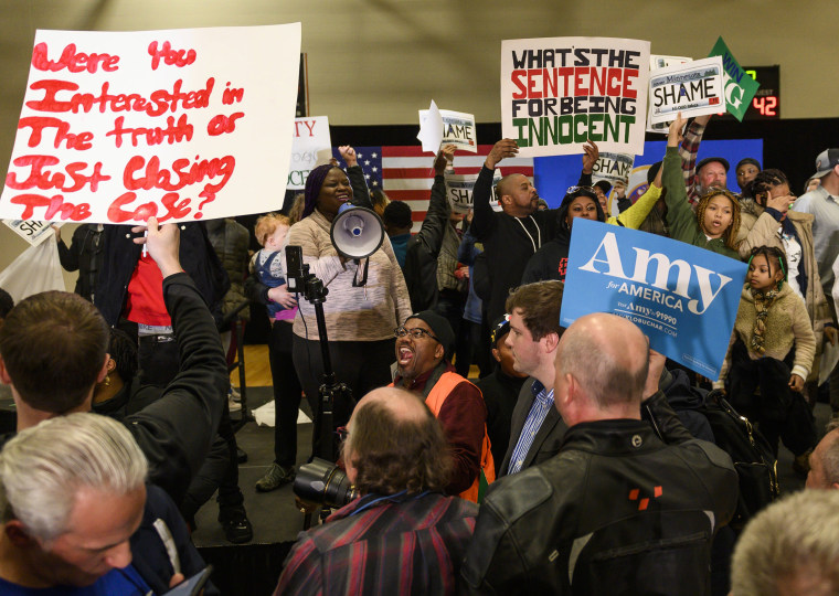 Image: Protesters celebrate after hearing that a campaign rally for Democratic presidential candidate Sen. Amy Klobuchar (D-MN) was cancelled after they took the stage