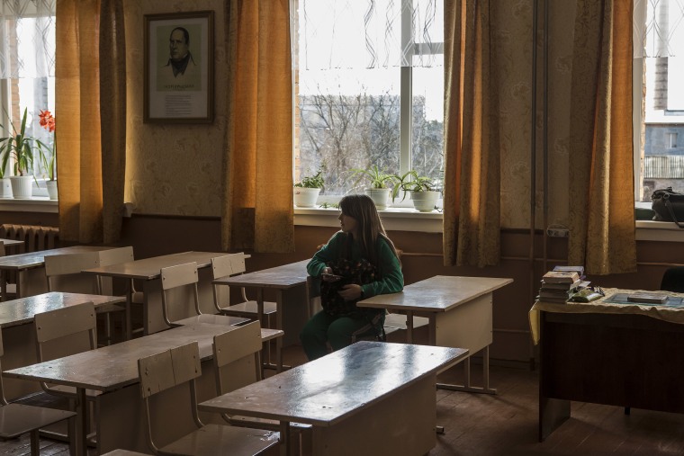 Image: A schoolgirl sits in an empty classroom in Novi Sanzhary, Ukraine