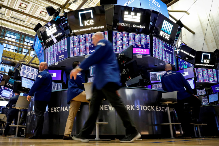 Image: Traders work on the floor at the NYSE in New York