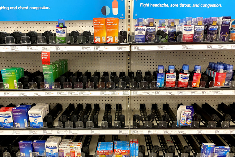 Image: Empty cold and flu medicine shelves are shown at a Target store in Encinitas, California