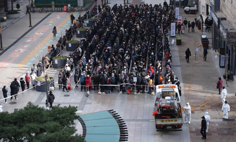 Image: People wait in line to buy face masks outside a department store in Seoul on Tuesday.