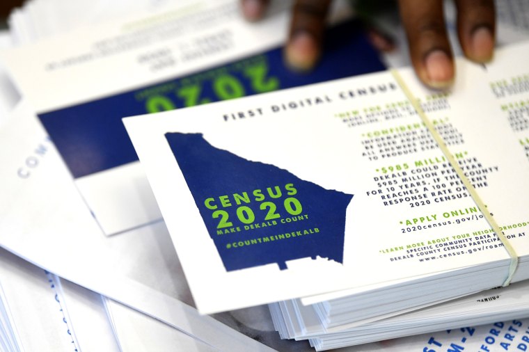 A worker gets ready to pass out instructions on how to fill out the 2020 census during a town hall meeting in Lithonia, Ga., on Aug. 13, 2019.