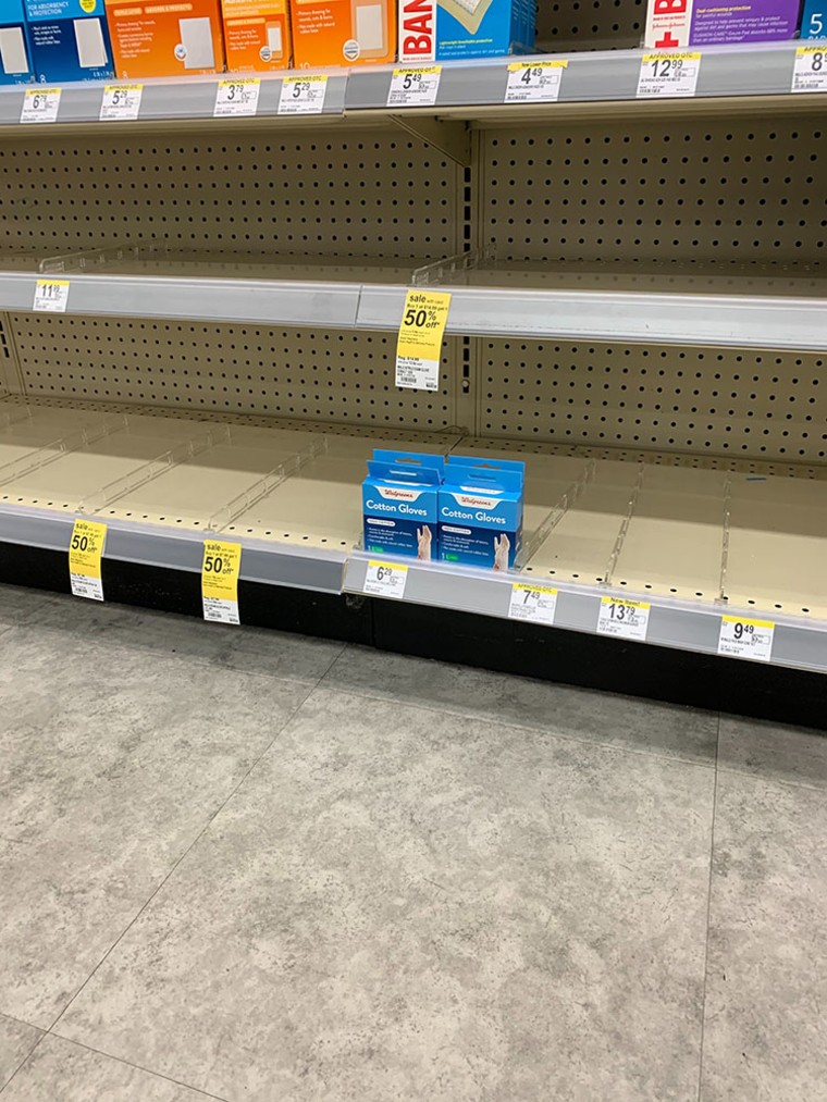 Image: A lone pair of gloves inside a Kirkland Walgreens, less than a mile from nursing home where at least 6 people have died from COVID-19.