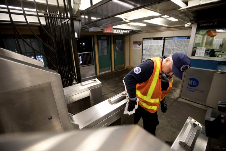 Image: MTA worker Duane Clark sanitizes the Avenue X subway station in Brooklyn on March 3, 2020.