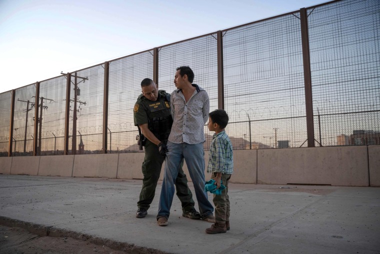Image: Jose is searched by a Customs and Border Protection Agent as his son, Jose Daniel, looks on near the border in El Paso, Texas, on May 16, 2019.