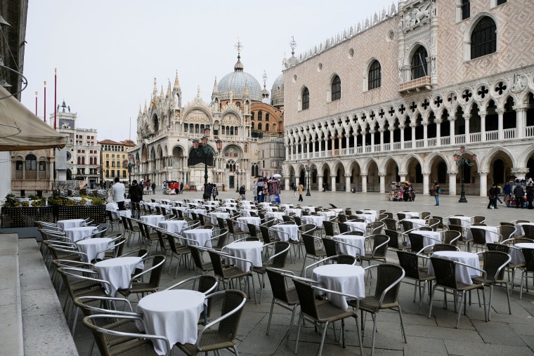 Image: Empty tables are pictured outside a restaurant at St. Mark's Square, which is usually full of tourists, after Italy's government adopted a decree with emergency new measures to contain the coronavirus, in Venice