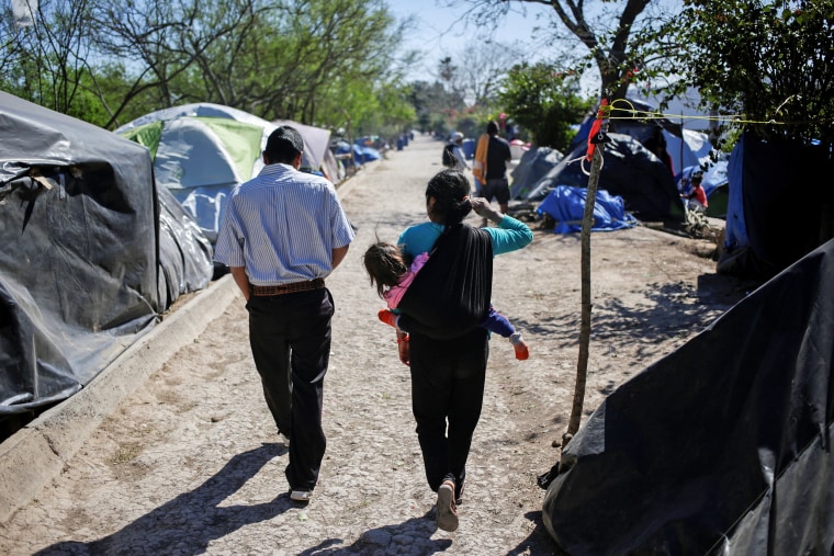 Image: Migrants, asylum seekers sent back to Mexico from the U.S. under the Remain in Mexico program officially named Migrant Protection Protocols (MPP), are seen at provisional campsite near the Rio Bravo in Matamoros