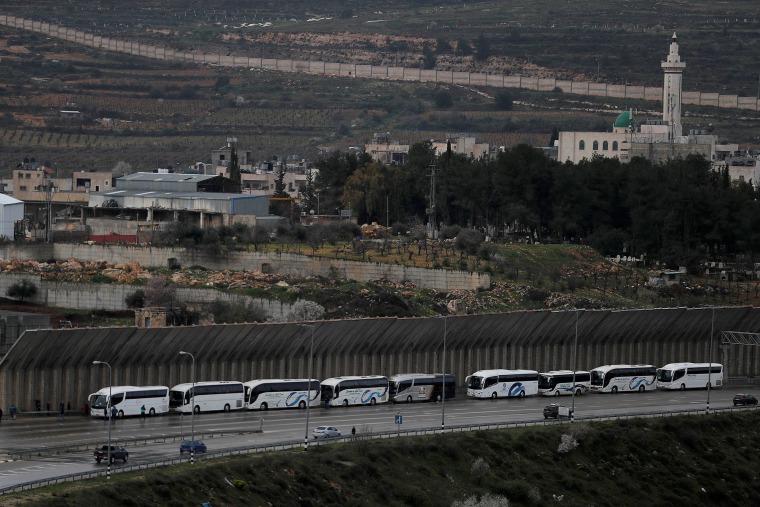 Image: Tourist buses wait at an Israeli checkpoint