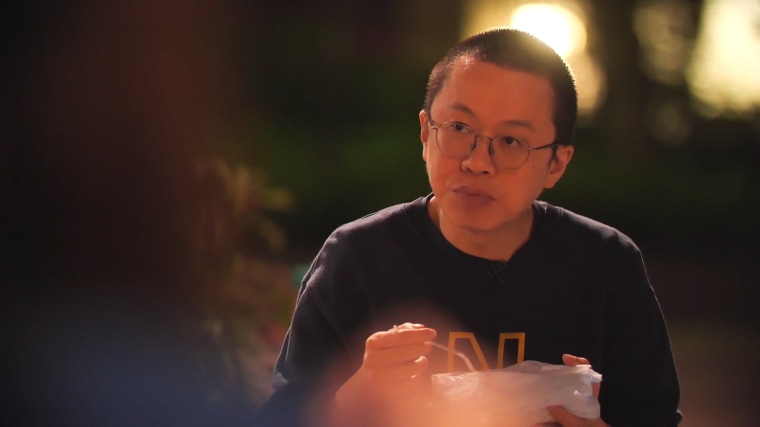 Image: Dr Alfred Wong, eating a takeaway in Hong Kong's Tue Mun Park, where he meets his wife for 10 minutes a day.
