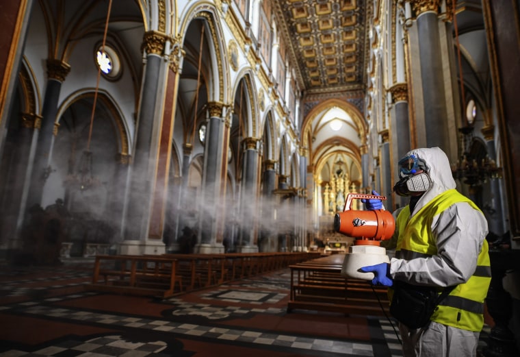 Sanitary workers disinfect the church of San Domenico Maggiore in Naples, Italy, on March 6, 2020.