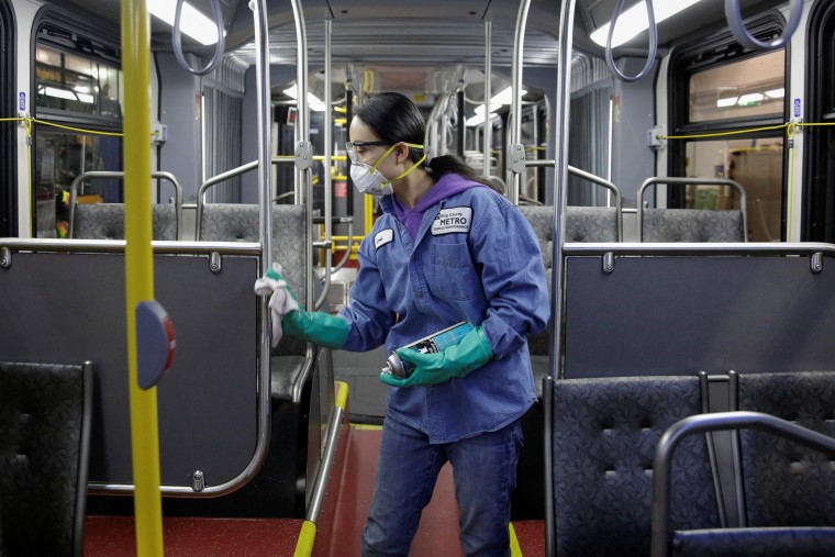 Image: FILE PHOTO: Vehicle Maintenance Utility Service Worker Thiphavanh 'Loui' Thepvongsa wipes down an off-duty bus with a disinfectant during a routine cleaning at the King County Metro Atlantic and Central Base in Seattle