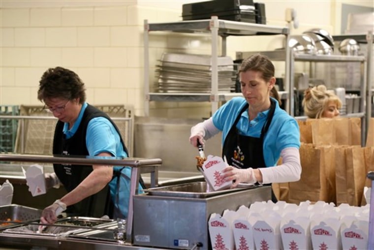 Cafeteria workers for the Northshore School District in Washington state prepare meals for students who must stay home on March 9, 2020.