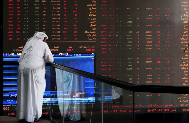 Image: A Kuwaiti trader checks stock prices at Boursa Kuwait in Kuwait City, on March 8, 2020.