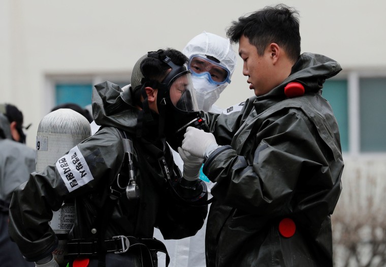 Image: South Korean soldiers from a chemical corps prepare to carry out quarantine works at an apartment complex which is under cohort isolation after mass infection of coronavirus disease (COVID-19) reported in Daegu, South Korea