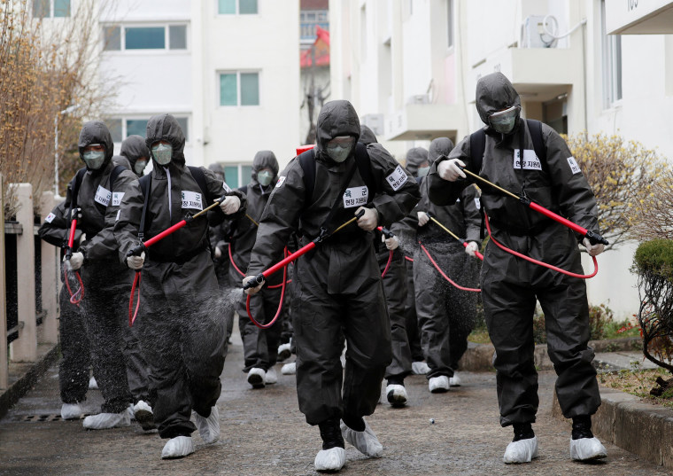 Image: South Korean soldiers spray disinfectants inside an apartment complex which is under cohort isolation after mass infection of coronavirus disease (COVID-19) in Daegu