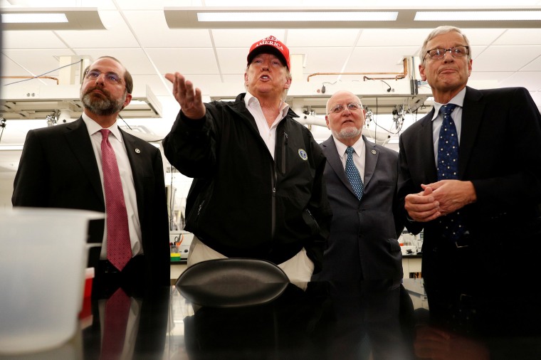 Image: President Donald Trump delivers remarks beside HHS Secretary Alex Azar and Centers for Disease Control, CDC Prevention Director Dr. Robert Redfield, and Associate Director for Laboratory Science and Safety Steve Monroe during a tour of the Center f