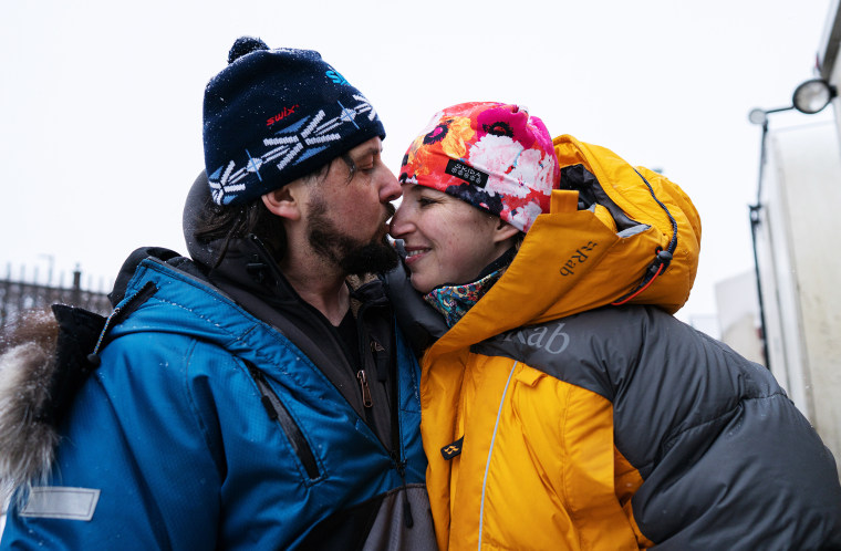 Image: Quince Mountain kisses his wife, musher and author Blair Braverman,