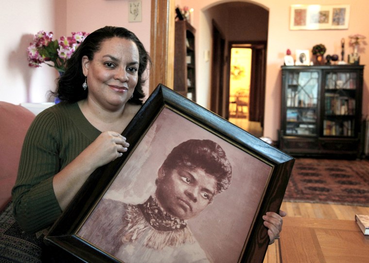 Michelle Duster, great-granddaughter of civil rights pioneer Ida B. Wells who led a crusade against lynching during the early 20th century, holds a portrait of Wells in her home in Chicago's South Side on Dec. 2, 2011.