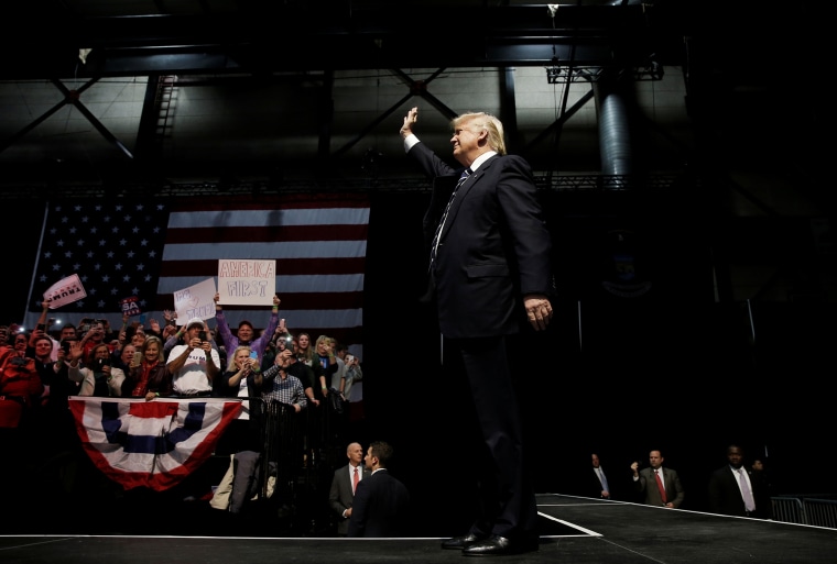 U.S. President-elect Donald Trump waves as he takes the stage at a \"Thank You USA\" tour rally in Grand Rapids