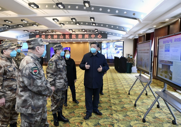 Image: Chinese President Xi Jinping, right, is briefed about the Huoshenshan Hospital in Wuhan in central China's Hubei Province