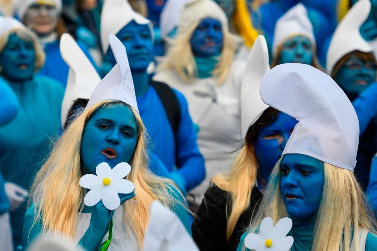 People dressed as Smurfs attend a world record gathering of Smurfs on March 7, 2020, in Landerneau, western France.