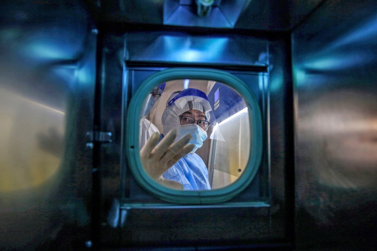 A medical staff member gestures inside an isolation ward at Red Cross Hospital in Wuhan in China's central Hubei province on March 10, 2020.